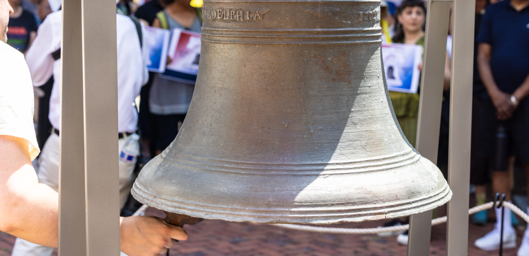 A replica liberty bell being rung at the vigil.