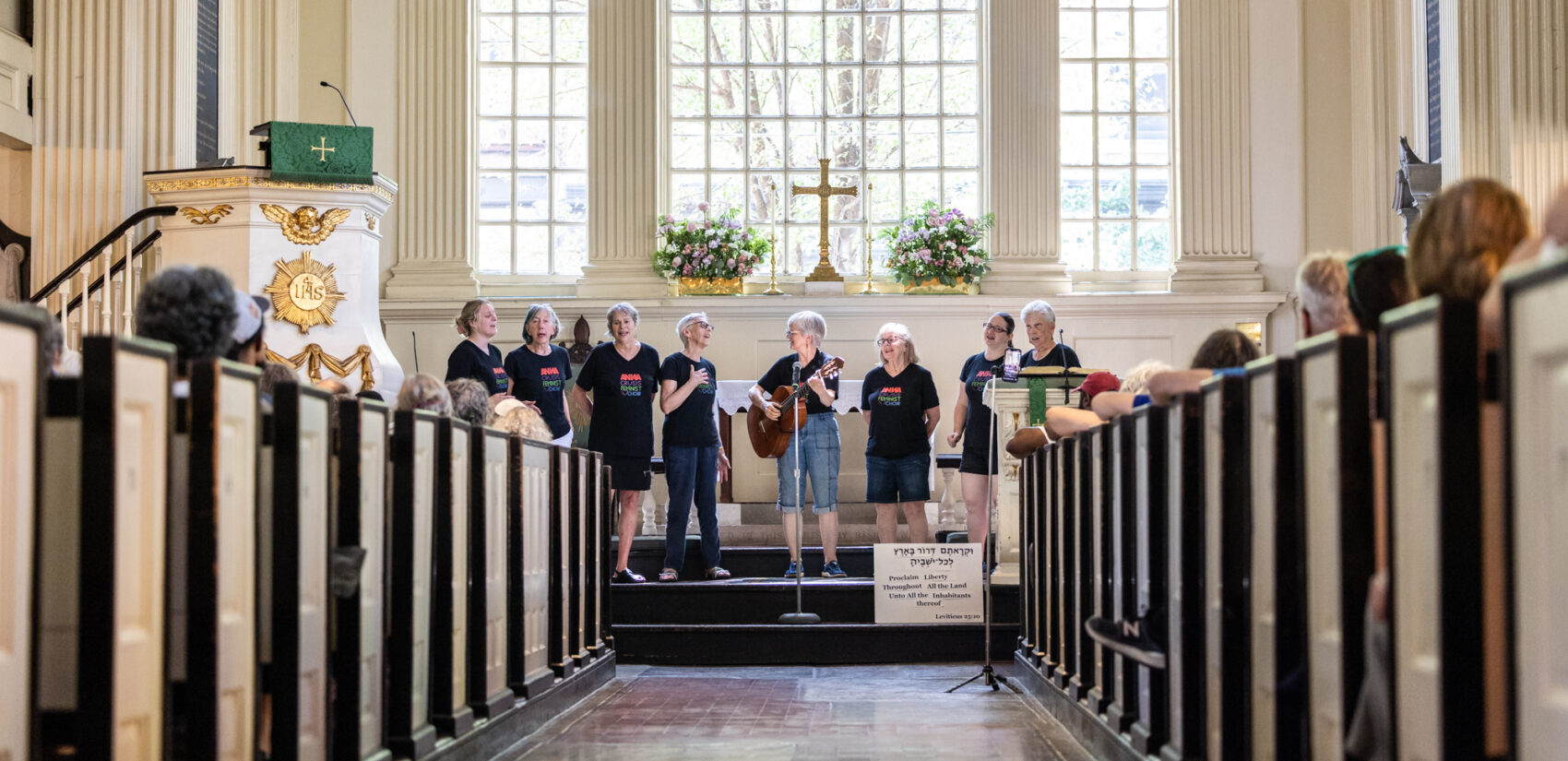 A choir singing on stage at the church.
