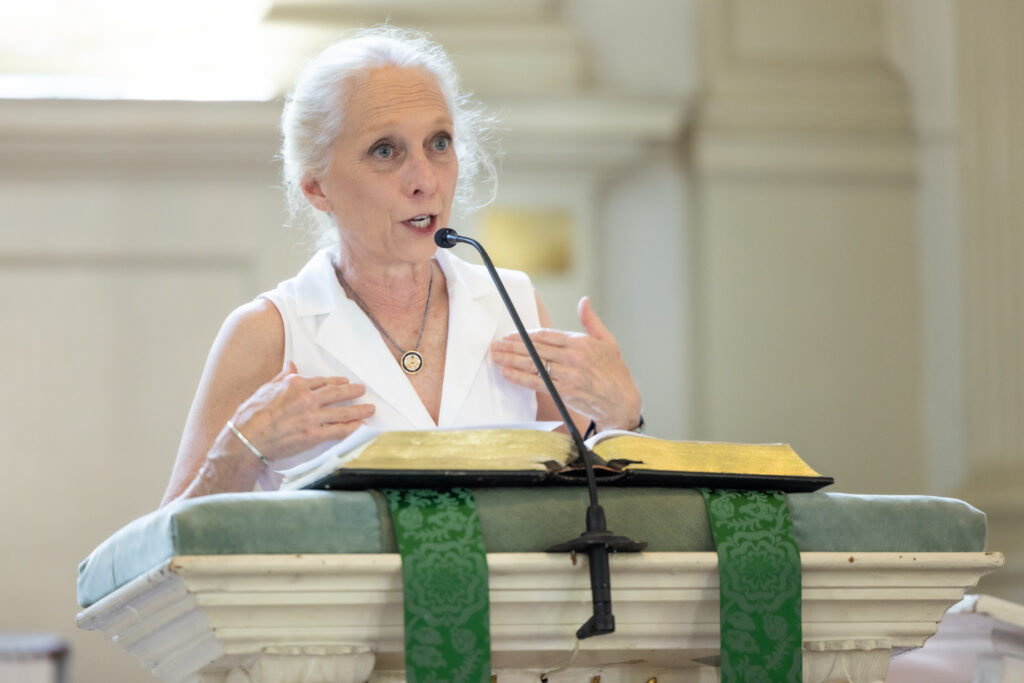 Mary Gay Scanlon speaking at a podium in the church.