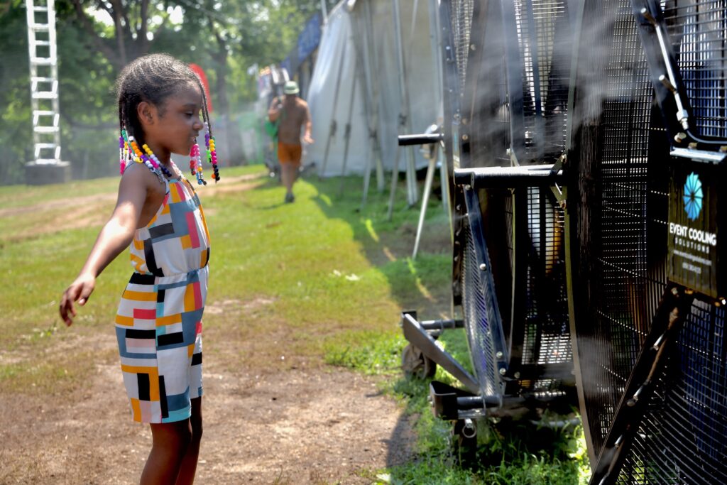 Liyana Mendez, 7, of Philadelphia cools off in the mist fans