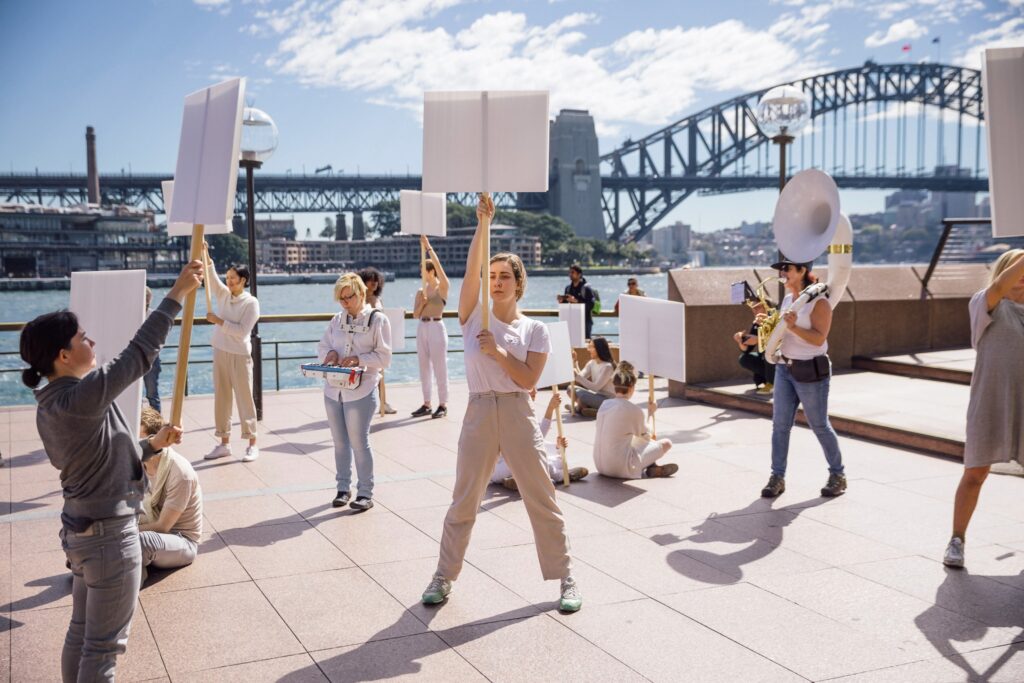 performers acting out a street protest with no protest messaging