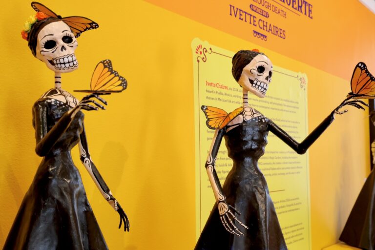Monarch butterflies adorn two figures in ''Living Through Death: Works by Ivette Chaires''
