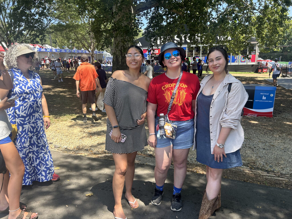 Three women stand outside at the Philadelphia FIFA Fan Fest