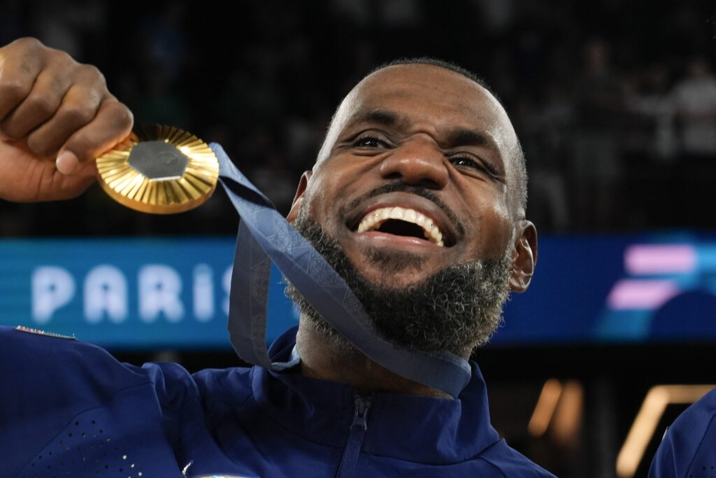 LeBronJames United States' LeBron James (6) celebrates after beating France to win the gold medal during a men's gold medal basketball game at Bercy Arena at the 2024 Summer Olympics, Sunday, Aug. 11, 2024, in Paris, France. (AP Photo/Rebecca Blackwell)