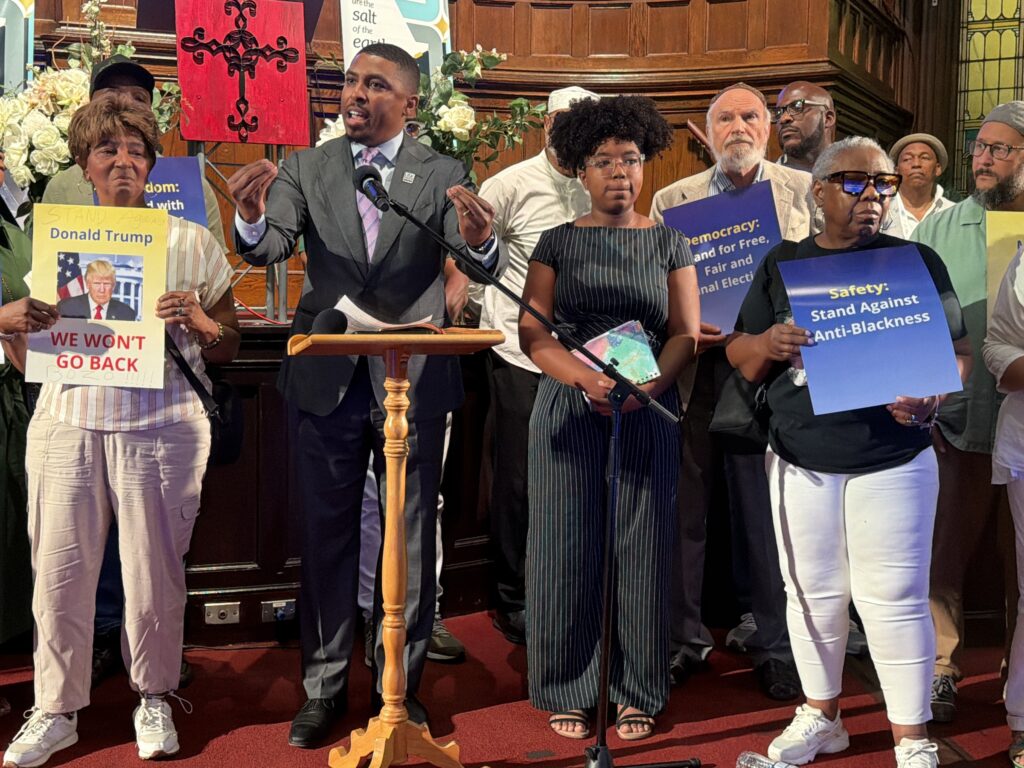 ORourke-krasner-allegations-crussell-2026-07-22 Nicholas O'Rourke speaking at a podium surrounded by supporters.