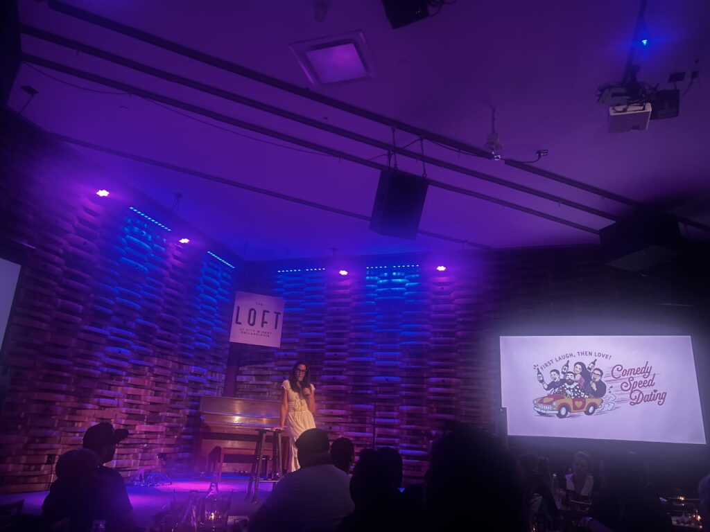 Kerryn Feehan performing at a speed-dating comedy event