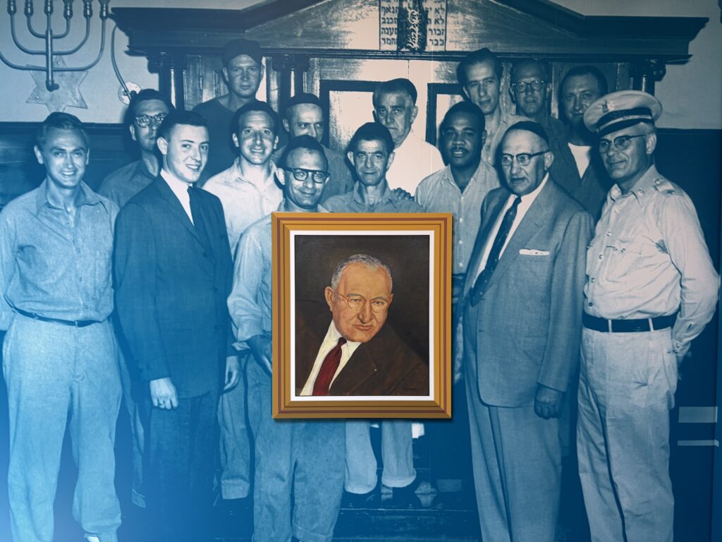 a large mural on the wall of people imprisoned, presenting a framed portrait to Joseph Paull.