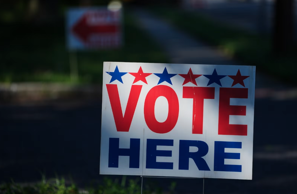 election-vote-here-sign-polling-place-AP-073026 A ''Vote Here'' sign on a lawn directs voters to a polling place for an election on June 2, 2026.