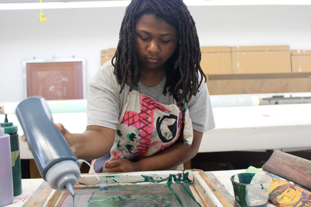fabric-workshop-museum-high-school-program-5 A woman participates in a screen printing program