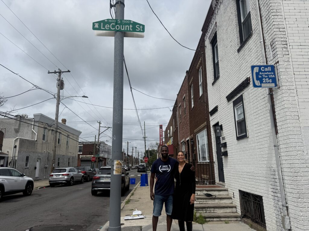 Executive director of the Young Chances Foundation Tyrique Glasgow and community activist Samaya Brown stand below a LeCount Street sign