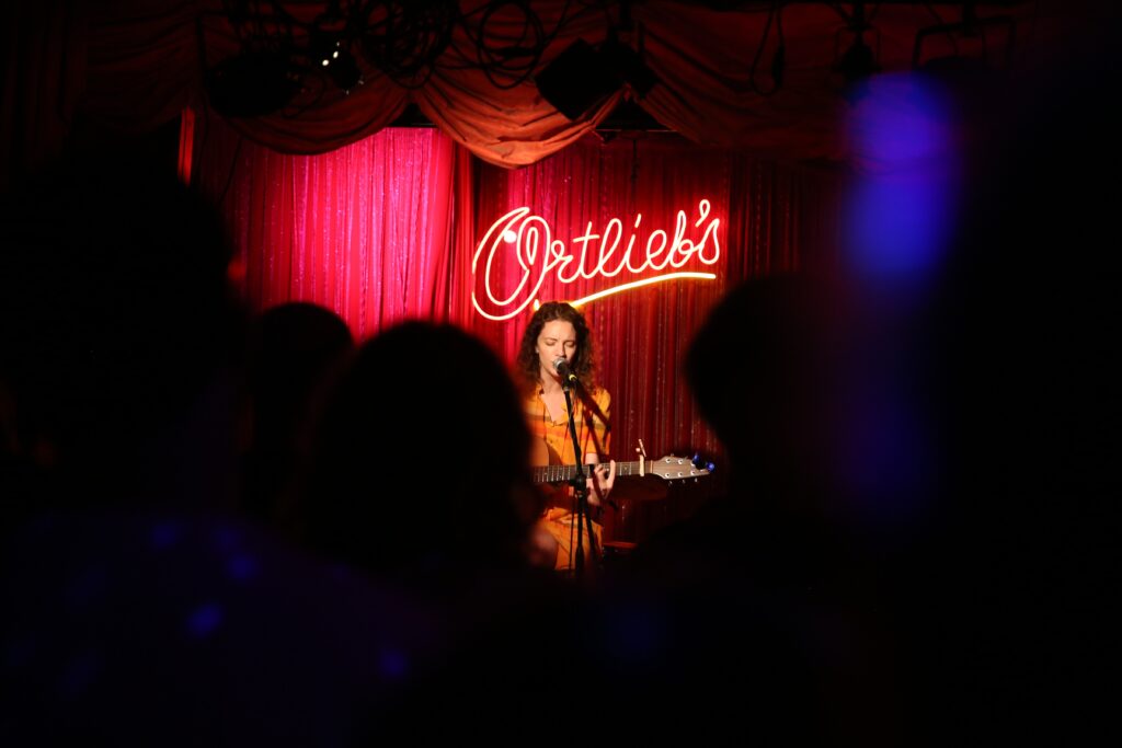 mallory-hawk-ortliebs-2026-07-22-3 Mallory Hawk singing and playing guitar onstage