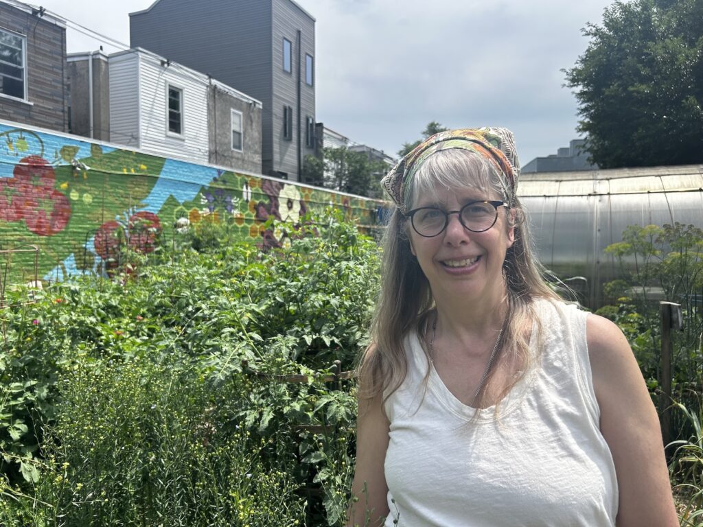Miranda Mote stands by her square yard of flax