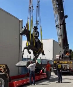 Statue being lifted by a crane