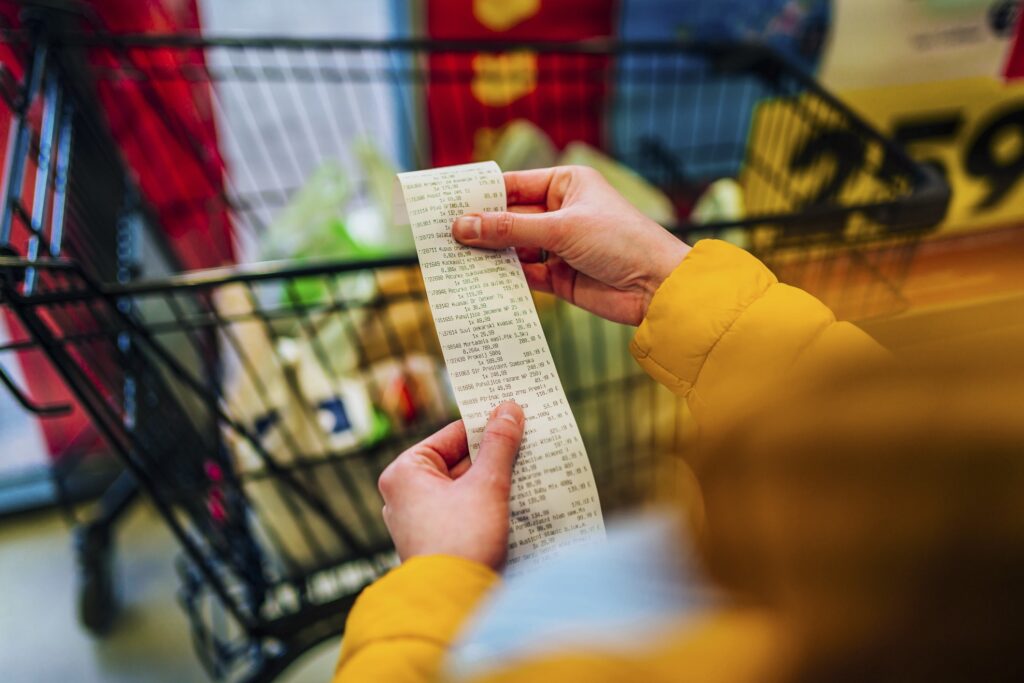 Checking the bill Woman checking the bill when paying at a supermarket