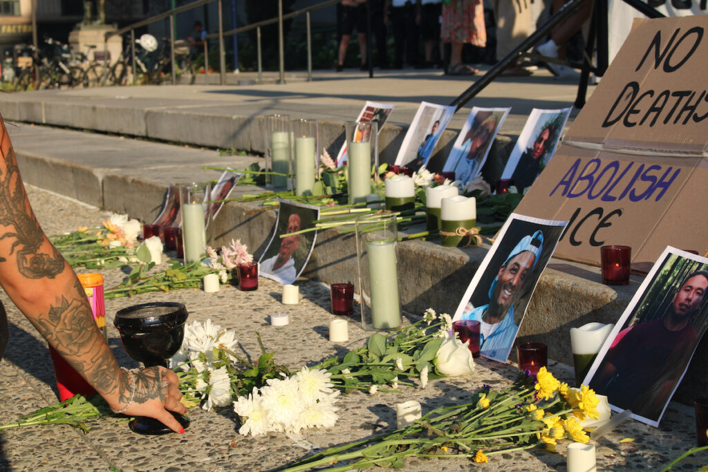 vigil-ice-3 An altar with photos, flowers and incense to honor those killed by immigration officers.
