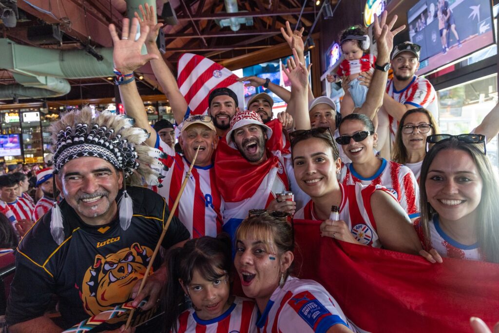Paraguay fans cheer on their team during the game.