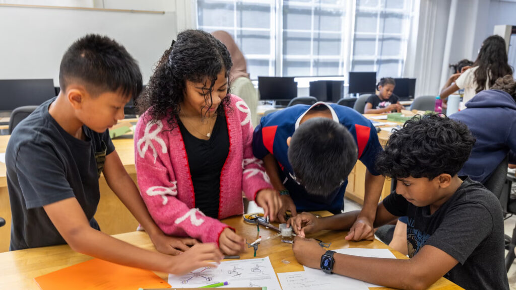08-06-2026-k-paynter-STEM-camp-Thomas-Jefferson-University-cropped Four children at a table building a drone