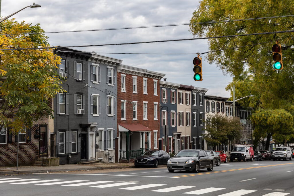 10-25-2023-k-paynter-wilmington-housing-file-10 copy Several rowhouses in Wilmington, Delaware near a traffic light