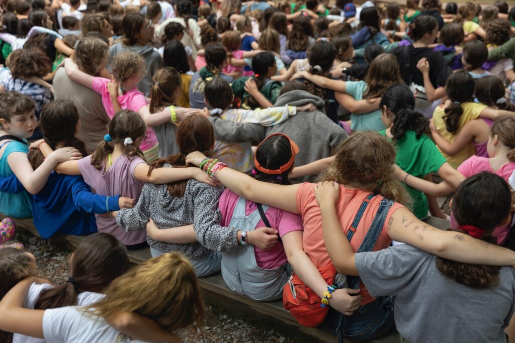 2021 07 10-r wisniewski-milford pa jewish summer camp-shabbat Campers place their arms around one another