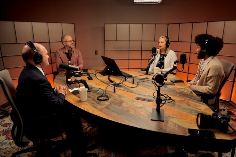 U.S. Sen. Chris Coons from Delaware (left) speaks with WHYY News reporters (from right) Kenny Cooper, Sarah Mueller and Carmen Russell-Sluchansky at WHYY Headquarters in Philadelphia on March 21, 2025.