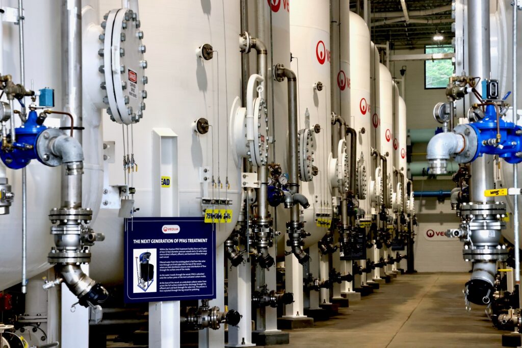 2025-06-18-e-lee-wilmington-del-stanton-water-treatment-plant-new-pfas-treatment-facility-tanks-and-sign-NU A line of tanks at a PFAS treatment plant in Stanton, Delaware