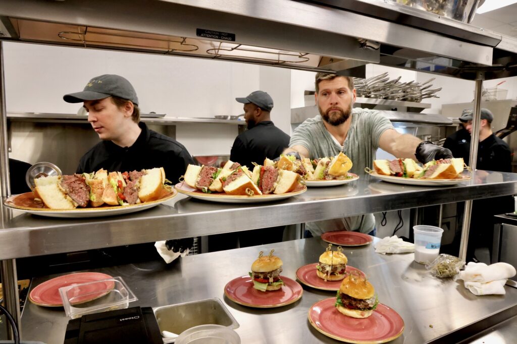 2026 08 11-e lee-philadelphia recipe philly-reality show restaurant poblano burgers Workers prepare poblano burgers during a pre-opening tasting day