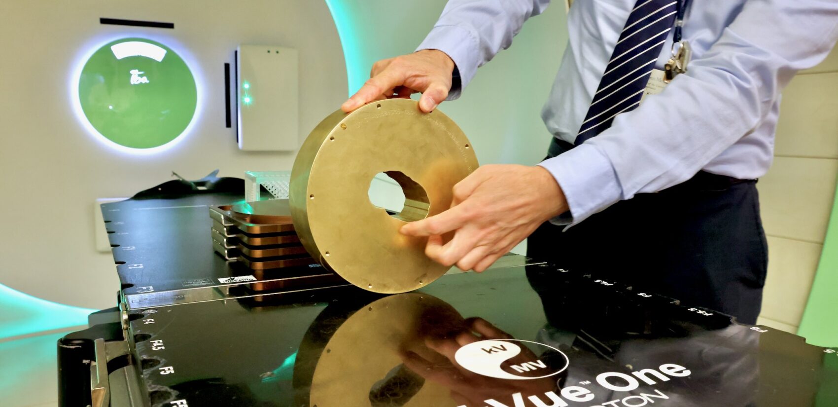 a brass aperture held by