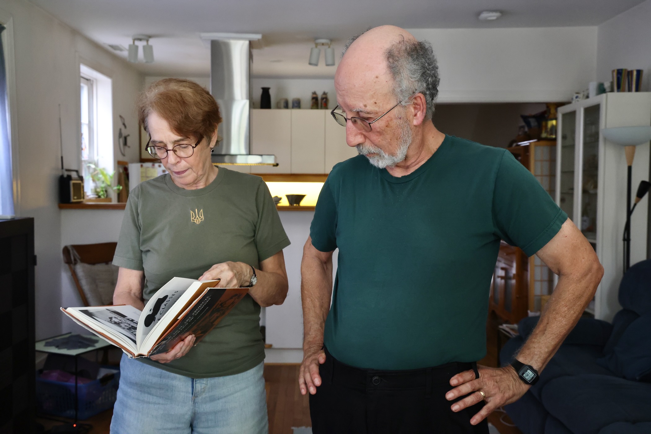 Virginia Maksymowicz and Blaise Tobia looking at a book