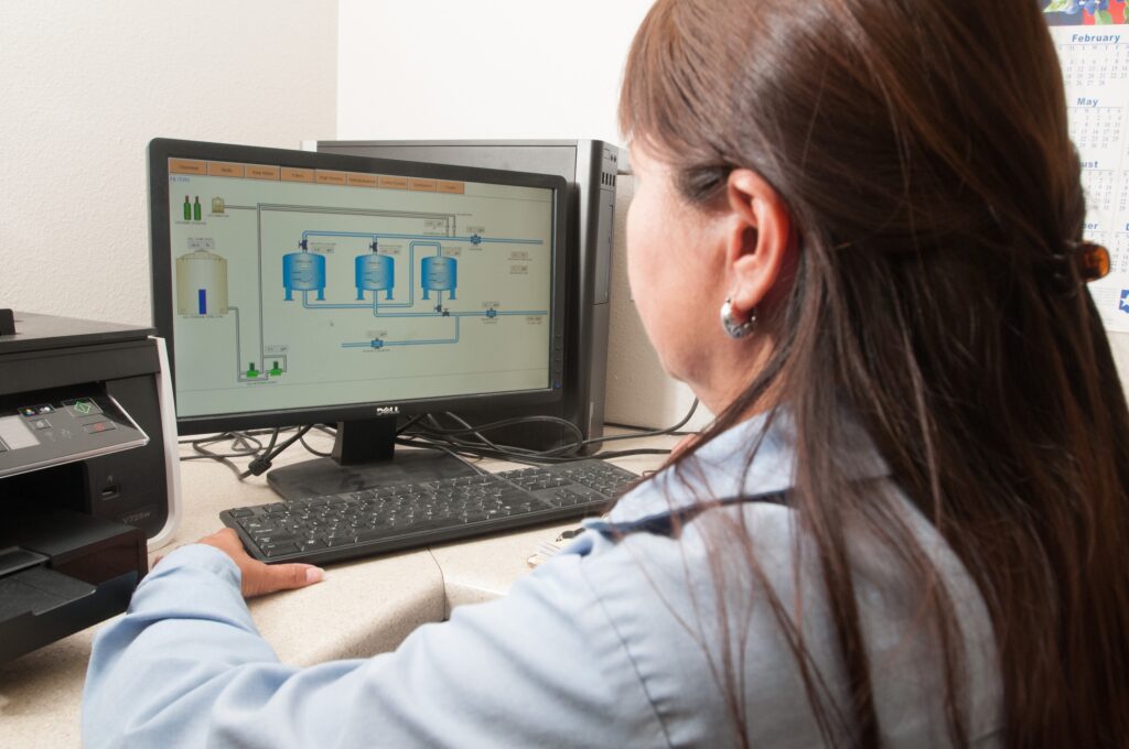 Freer_Water_Control_and_Improvement_District_-_Diana_Adame a worker looks at a computer to a water treatment facility