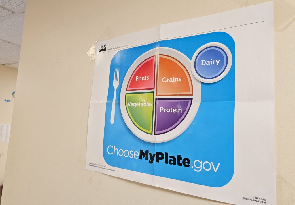 Obesity talk 1 Posters about healthy eating and nutritious foods hang on the wall