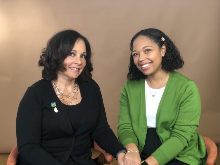 Sue Levy Giles and Alexandria Warner pose for a photo while sitting down