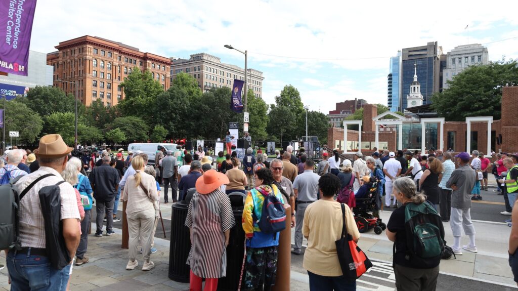 Many people are gathered on Independence Hall at the location of the President's House site.