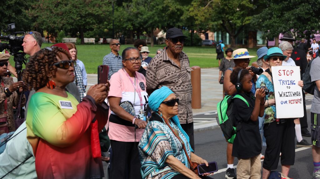 atac-rally-csharber-2025-08-25-8 Many people are gathered on Independence Hall at the location of the President's House site.