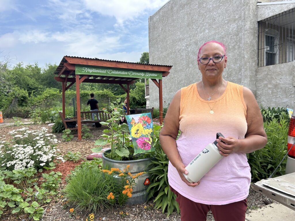 bus-shelters-SS-080726-04 Jacqueline M. Santiago-Vicente standing in the Byron Street community garden