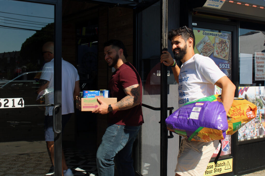 Men carry recovery packages meant for Colombia through a door