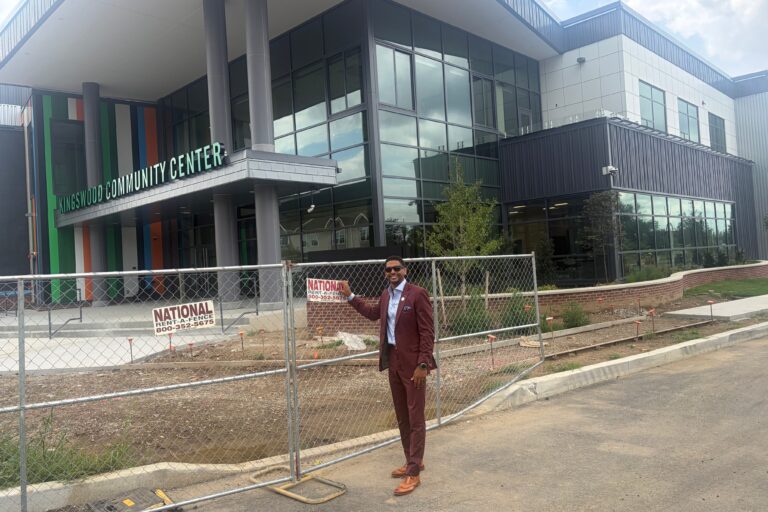 Logan Herring smiles in front of the Kingswood Community Center