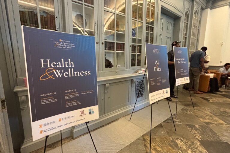 three signs read HEALTH & WELLNESS, AI & DATE AND EDUCATIONAL EXCELLENCE