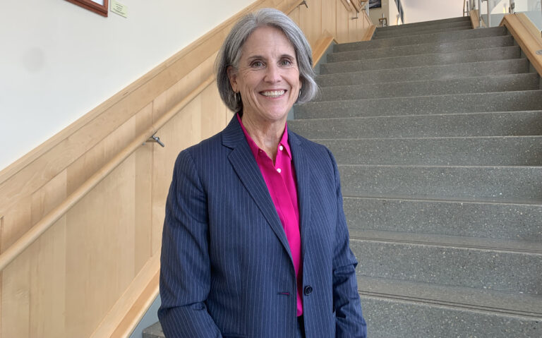 Rehoboth Beach Mayor-elect Susan Stewart poses for a photo in a blue blazer and pink undershirt