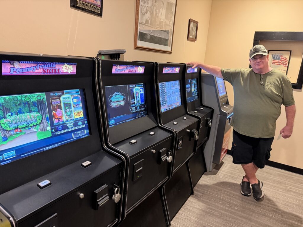skill-games-pat-mcmullen-MR-082026 Pat McMullen, president of the Knights of Columbus Regina Coeli Home Association in Northeast Philadelphia, stood next to skill game terminals in the organization’s bar.