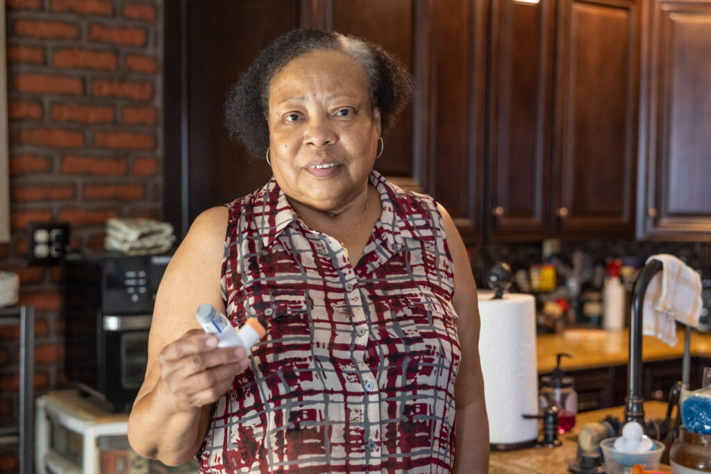 Carolyn Moseley, who suffers from asthma, holds an inhaler.
