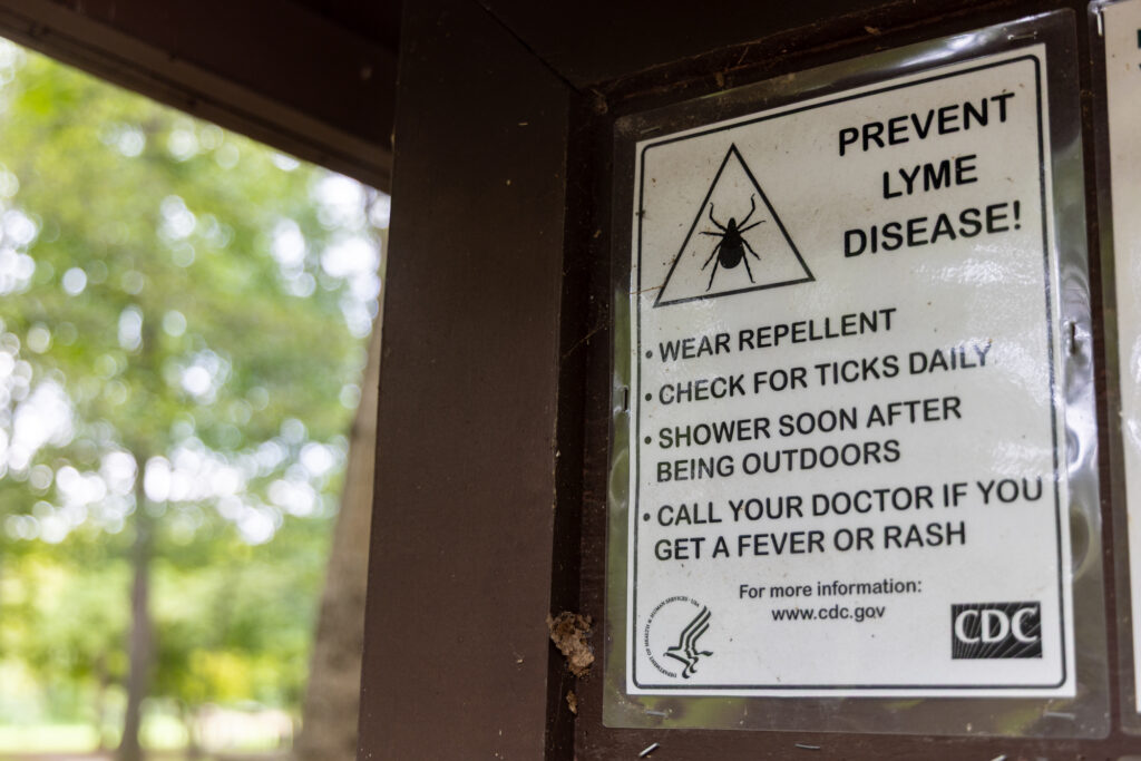 09 04 2026 k paynter tick file a sign reads PREVENT LYME DISEASE! WEAR REPELLENT, CHECK FOR TICKS DAILY, SHOWER SOON AFTER BEING OUTDOORS, CALL YOUR DOCTOR IF YOU GET A FEVER OR RASH For more information www.cdc.gov