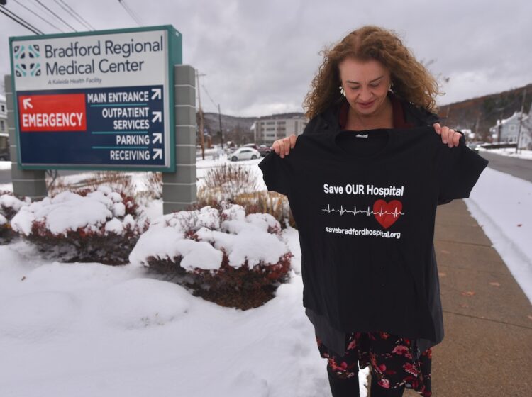 Margie Brown, a native of Bradford, PA, holds up a T-shirt that says “Save Bradford Hospital.” The local grassroots group of the same name was dedicated to advocating for the return of Bradford Regional Medical Center as a full-service hospital and securing better healthcare access for the community.