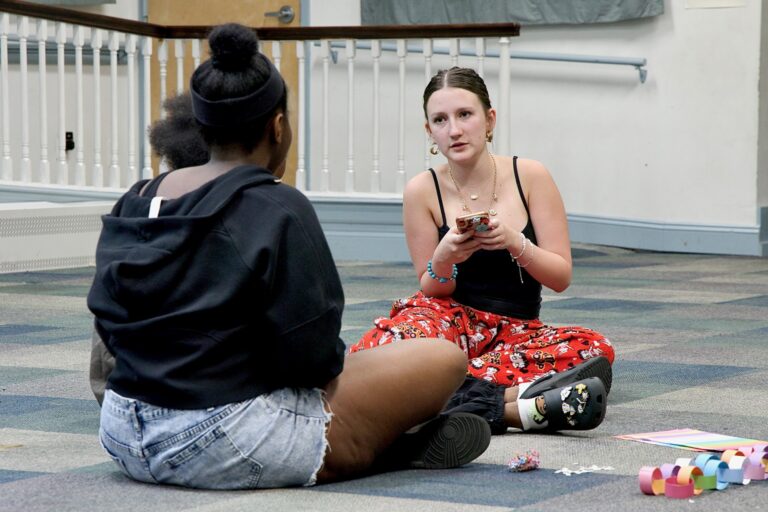 Nola Larson (right) works with other high teens to write the script for a play