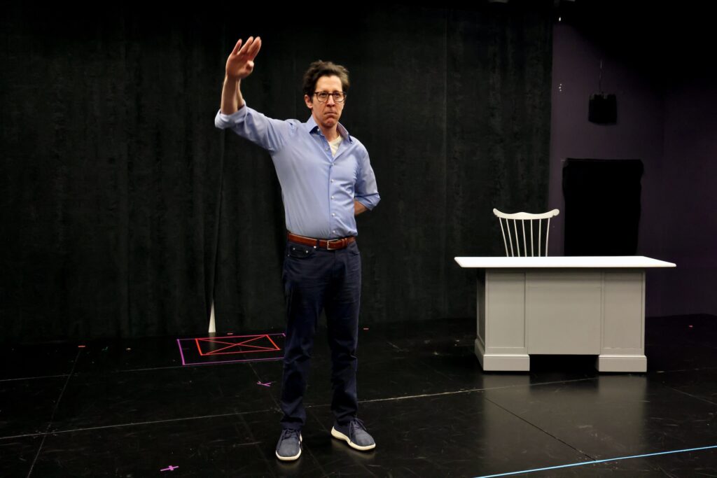 Joe Torsella on stage rehearsing his one-man show.
