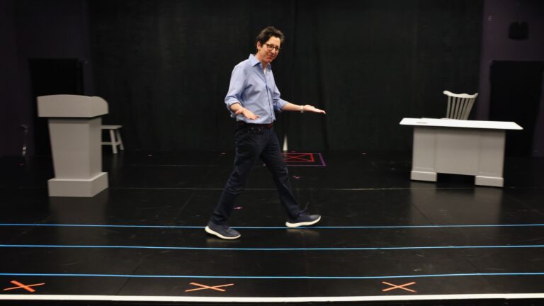Joe Torsella on stage rehearsing his one-man show.