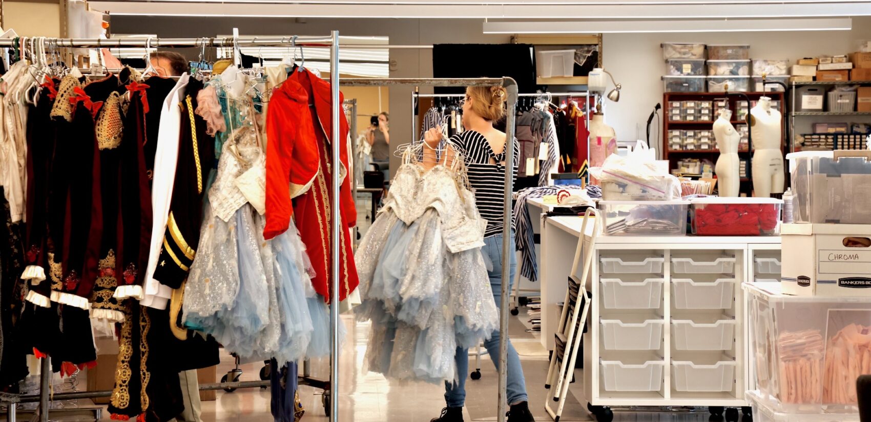 Many costumes hang on a rack in the Philadelphia Ballet's costume room.
