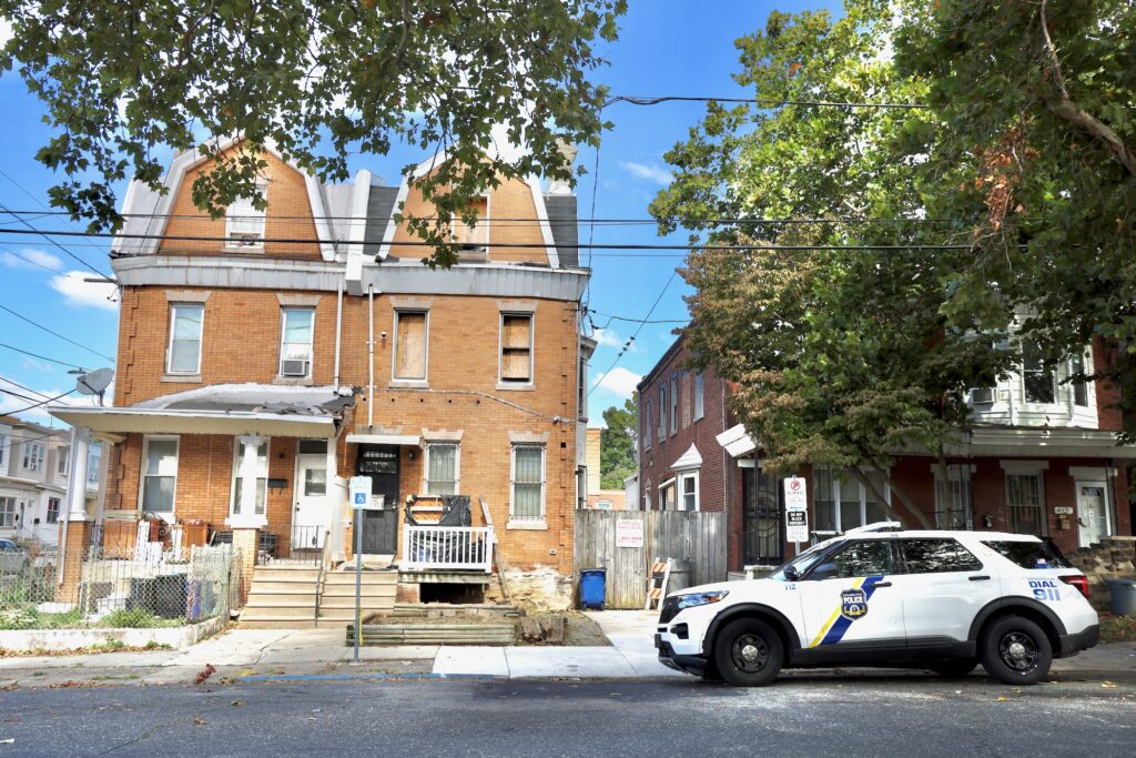 A police car idles outside the former home of R.C. Horsch on West Chew Avenue in Philadelphia's Olney neighborhood