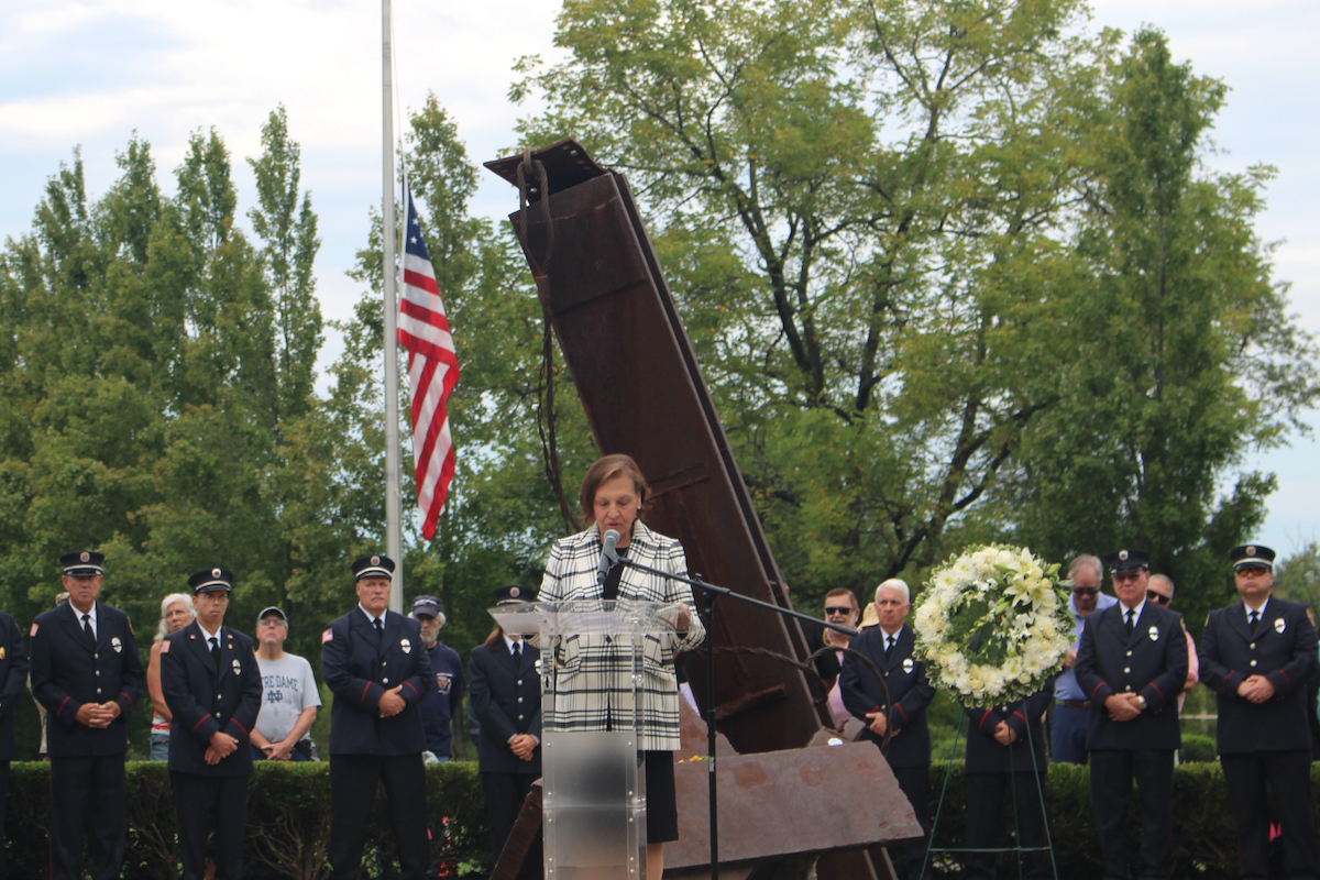 Judi Reiss speaks at a ceremony at The Garden of Reflection