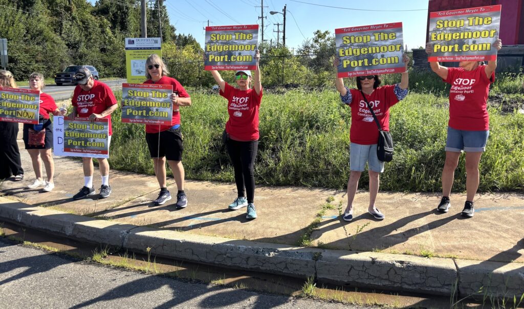 Edgemoor protesters-2026-09-14 Nearby residents of the Edgemoor site wearing matching red t shirts hold up signs protesting the development site.