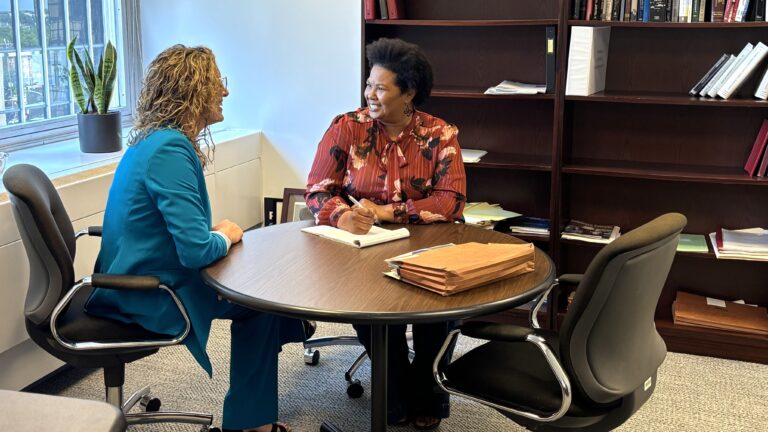 Sarah Rhine and Rena Scott at a desk